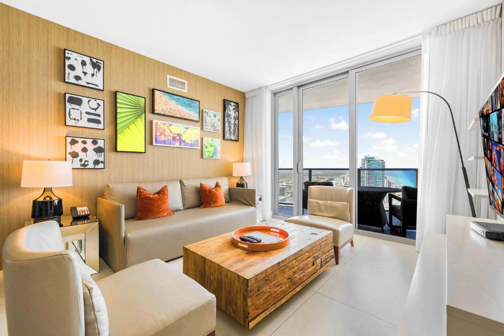 a living room with a couch and a table at Oceanfront Retreat Steps from Hollywood Beach in Hollywood Beach