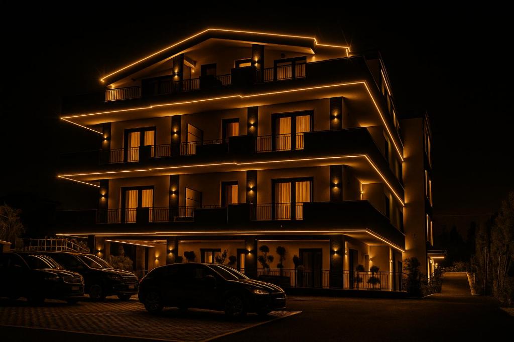 a lit up building at night with cars parked in front at RESIDENCE MARCO POLO in Montesilvano