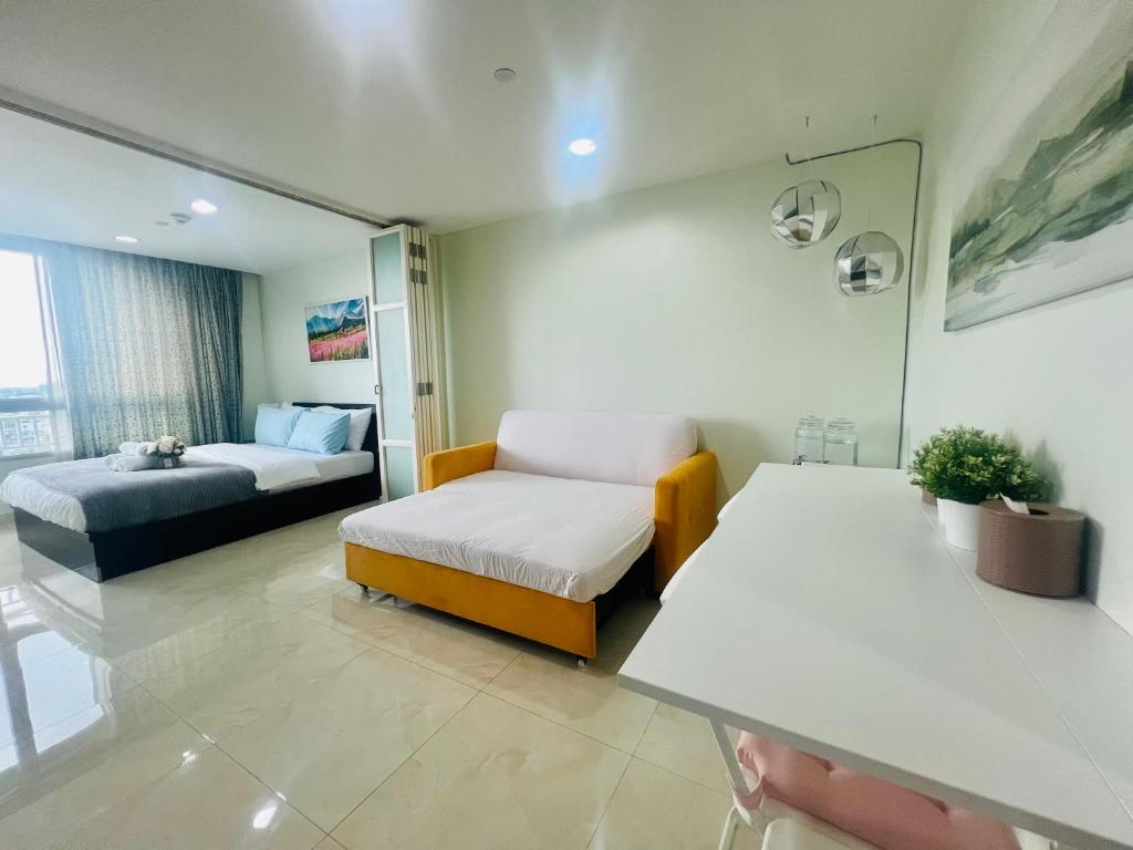 a room with a couch and a bed in a room at The Station Condo1 in Bangkok