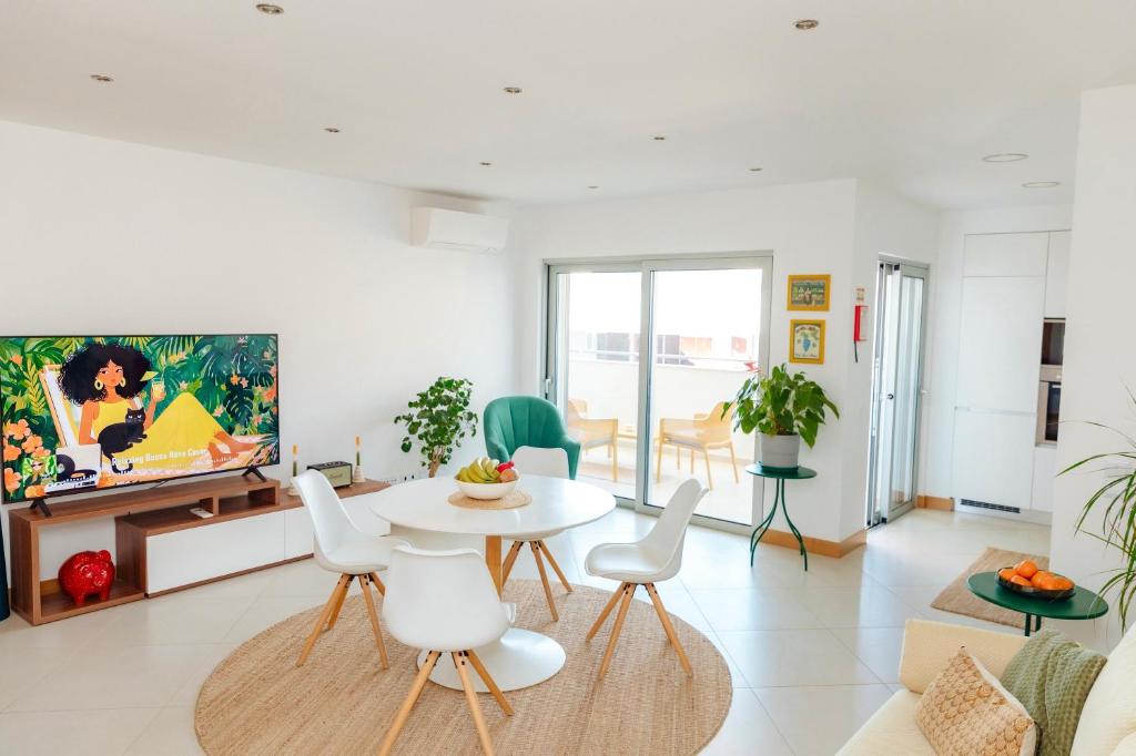 a living room with a table and chairs at Ocean Green Retreat Lagos in Lagos