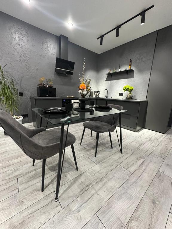 a dining room with a table and two chairs at Grey Harmony room in Almaty