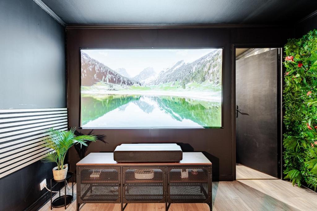 a room with a window with a view of a lake at Secret SPA Jacuzzi & Cinema in Grenoble