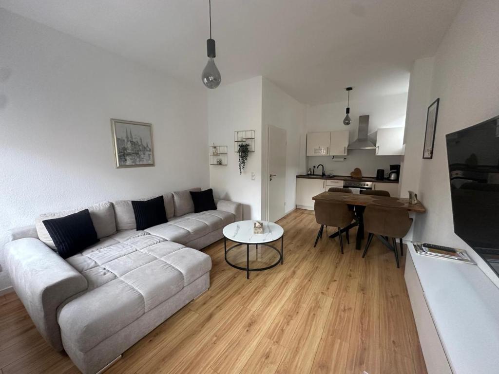 a living room with a couch and a table at Altstadtinsel am Johanneum in Lübeck