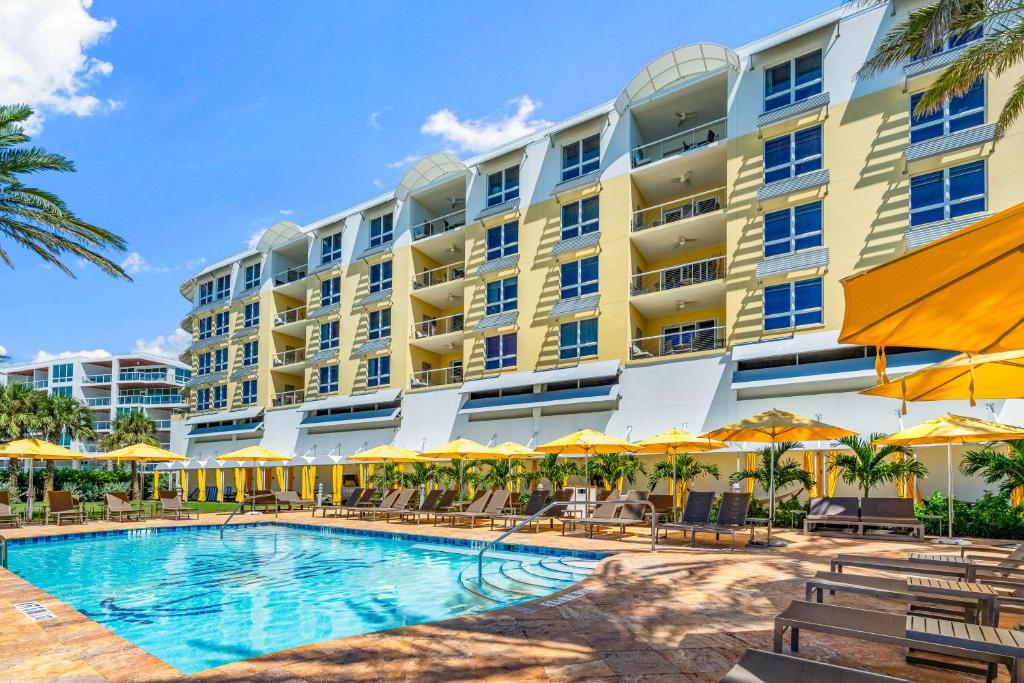 Beach Residences On Siesta, aka The Hyatt في سيستا كي: فندق كبير فيه مسبح وكراسي ومظلات