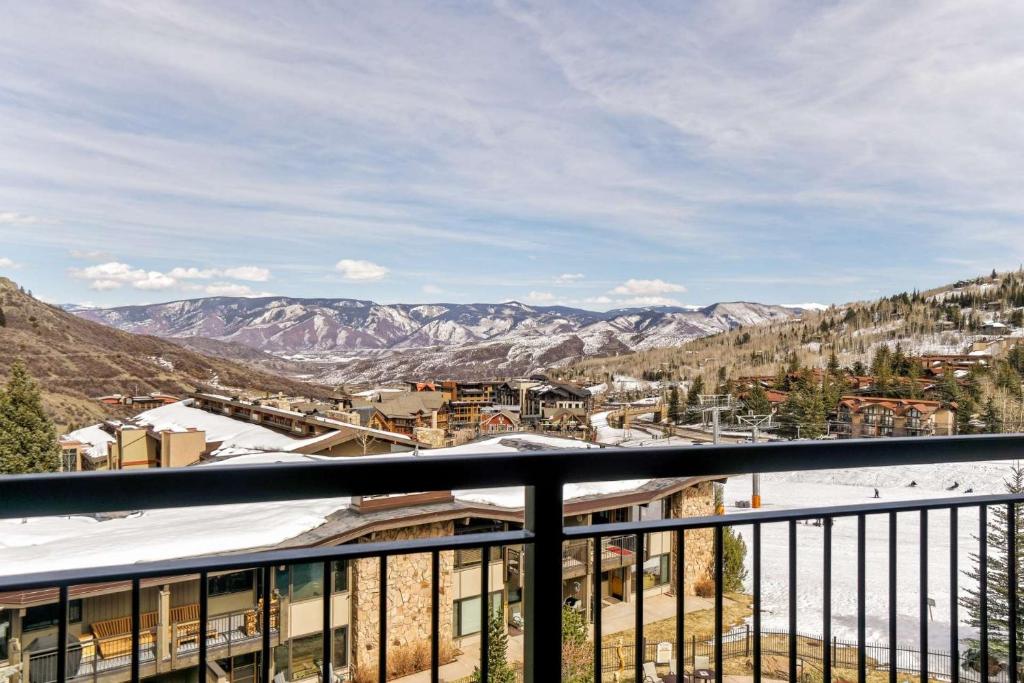 a view from the balcony of a resort with snow covered mountains at Shadowbrook 303 in Snowmass Village
