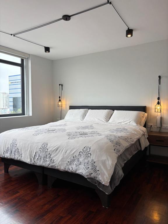 a white bedroom with a large bed and a window at Exclusive King Suite All inclusive amenities Miraflores Center in Lima