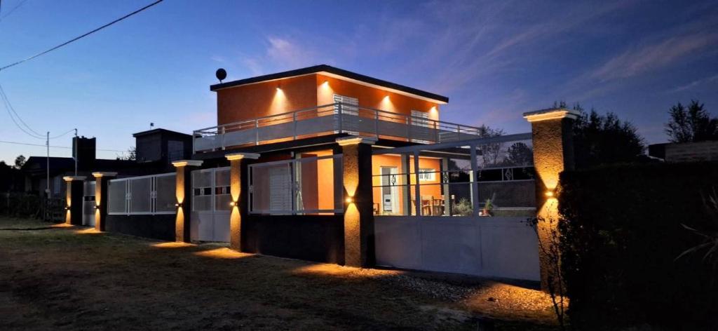 a large house with lights on it at night at La Orlinda in Potrero de Garay