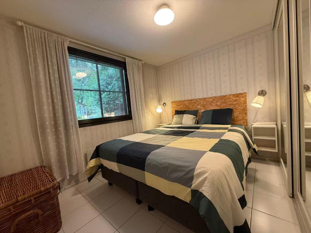 a bedroom with a bed and a window at Nordic Nest in Vantaa