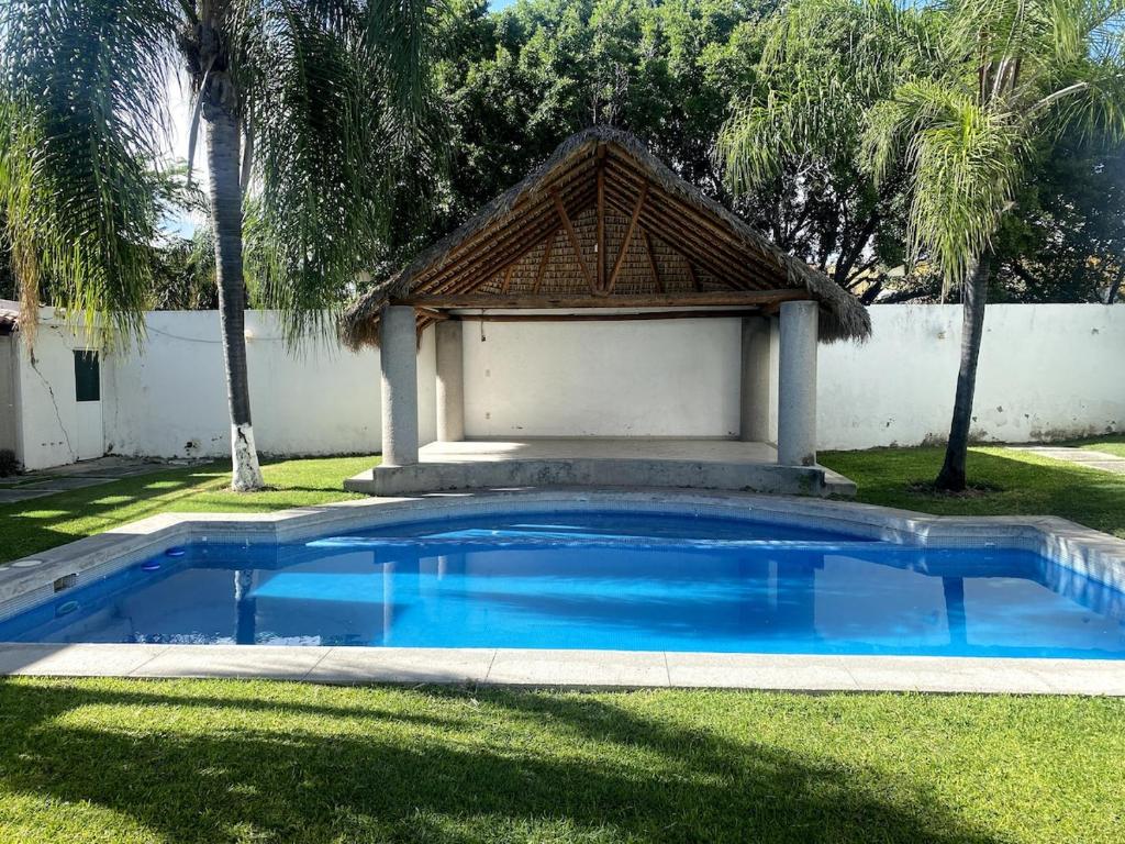 a swimming pool with a gazebo in a yard at Casa Bilbao in Chiconcuac