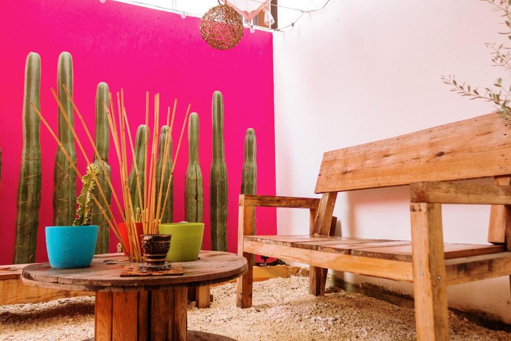 a room with a table and a bench and cactus at Departamento-Rinconcito Uxmal in Playa del Carmen