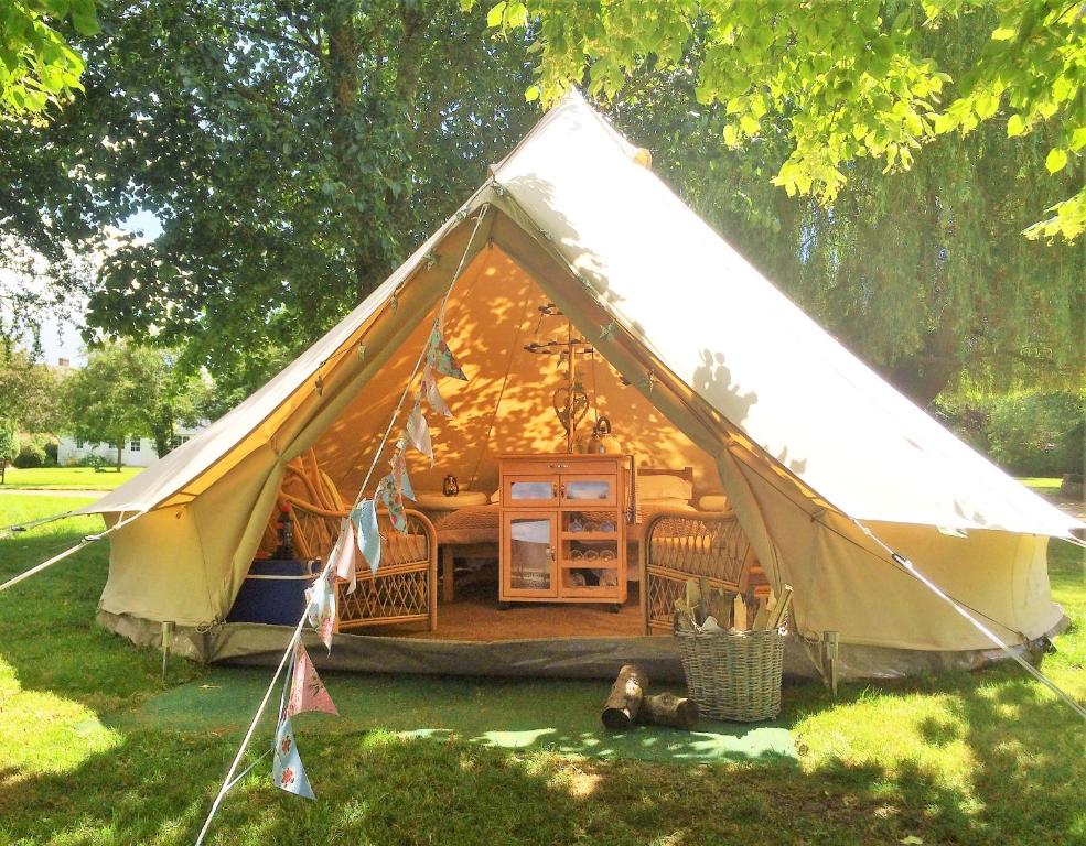 a large tent with a bed in the grass at Oxford Riverside Glamping in Oxford