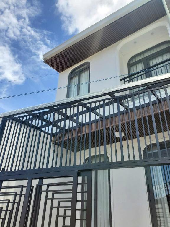 a balcony on the side of a house at Vibestay in Da Thien