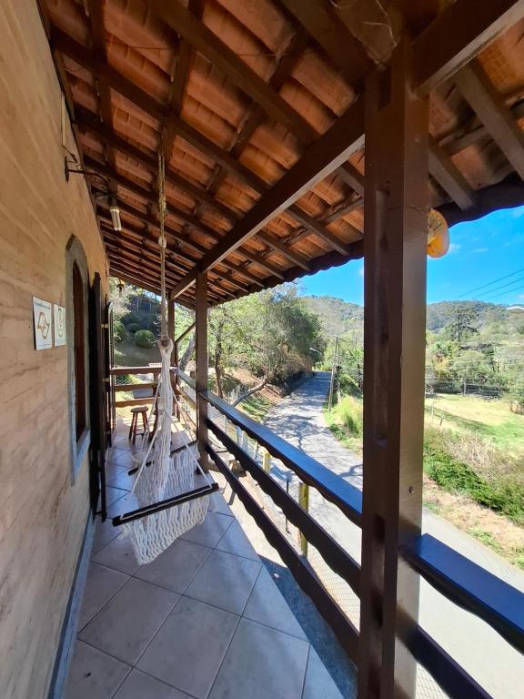 a porch of a house with a view of the mountains at Chalés São Francisco I in Santo Antônio do Pinhal