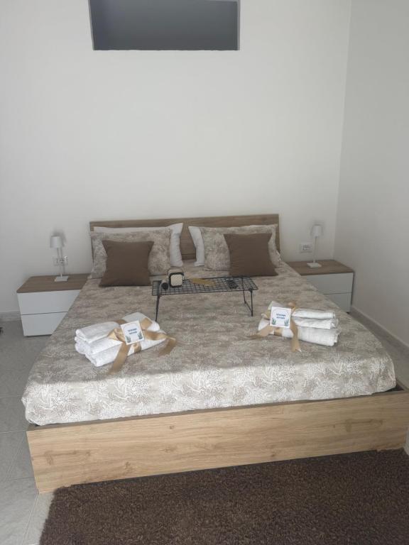 a bedroom with a bed with towels on it at Home Sorrento in Torre del Greco