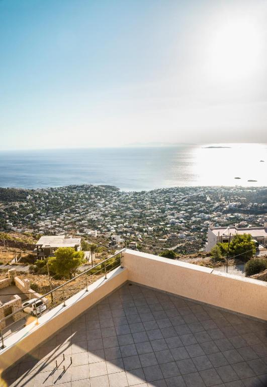 a view of the ocean from the balcony of a house at Viva B&B in Anavyssos