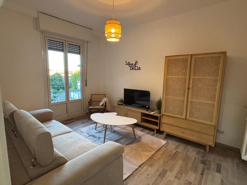 a living room with a couch and a table at NEW Brenta 10 minutes To Duomo M3-15 minutes to Linate - Full furnished APT with AC, Wi-fi and more in Milan