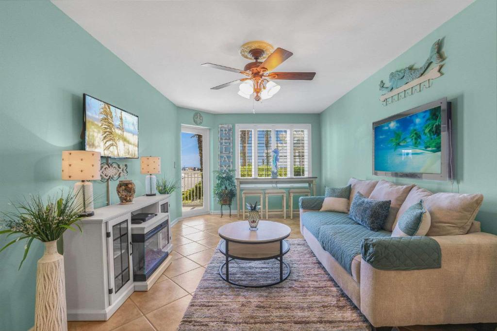 a living room with a couch and a ceiling fan at Grand Caribbean 111 Beach View Condo pool views in Orange Beach