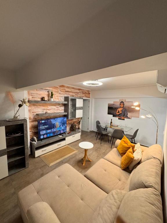 a living room with a couch and a flat screen tv at Brisa Marina in Grao de Castellón