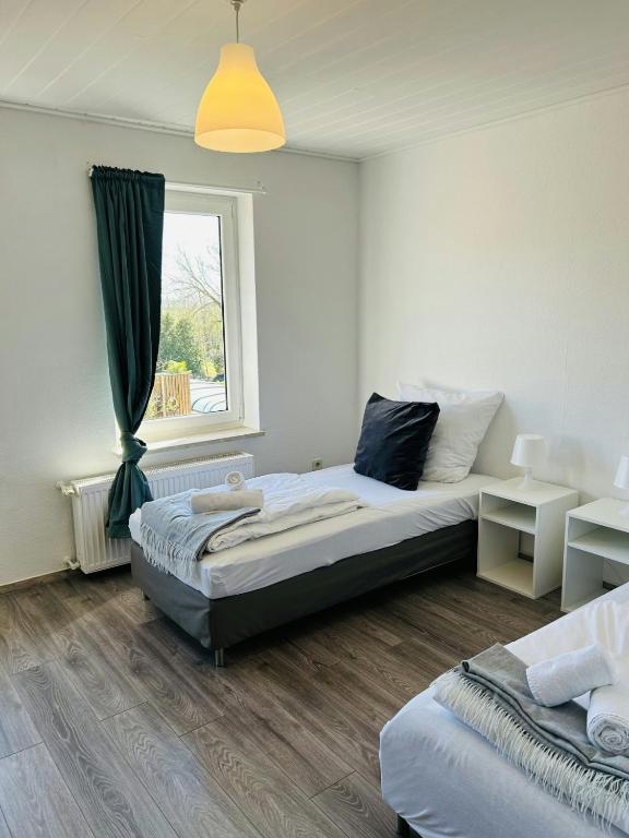 a bedroom with two beds and a window at Spacious Apartment for 6 in Bobitz