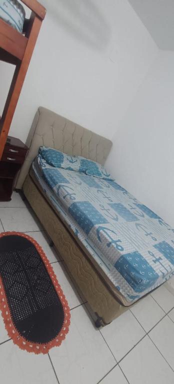 a bed sitting on the floor in a room at Tia do Coco Recanto in Caraguatatuba
