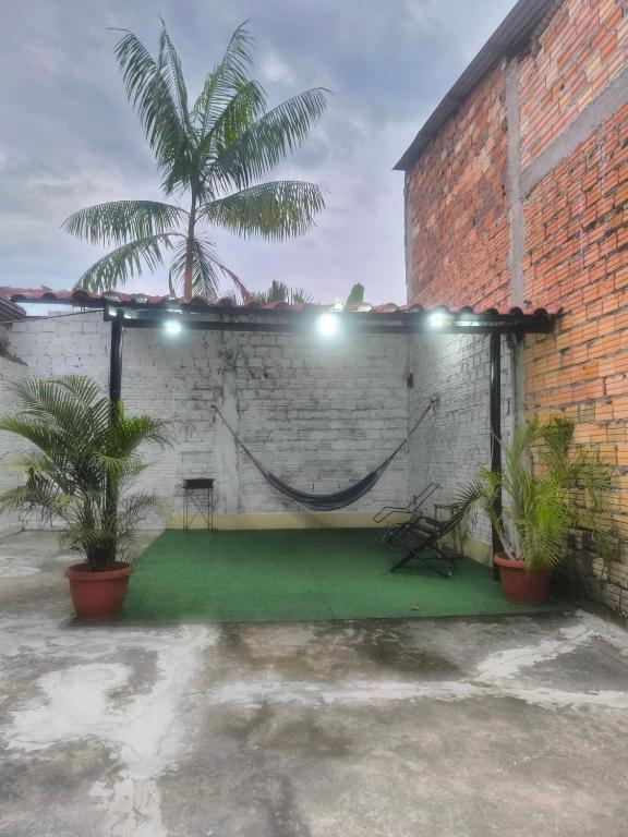 a brick wall with a green floor in a courtyard at Acogedor apartment in Iquitos in Iquitos