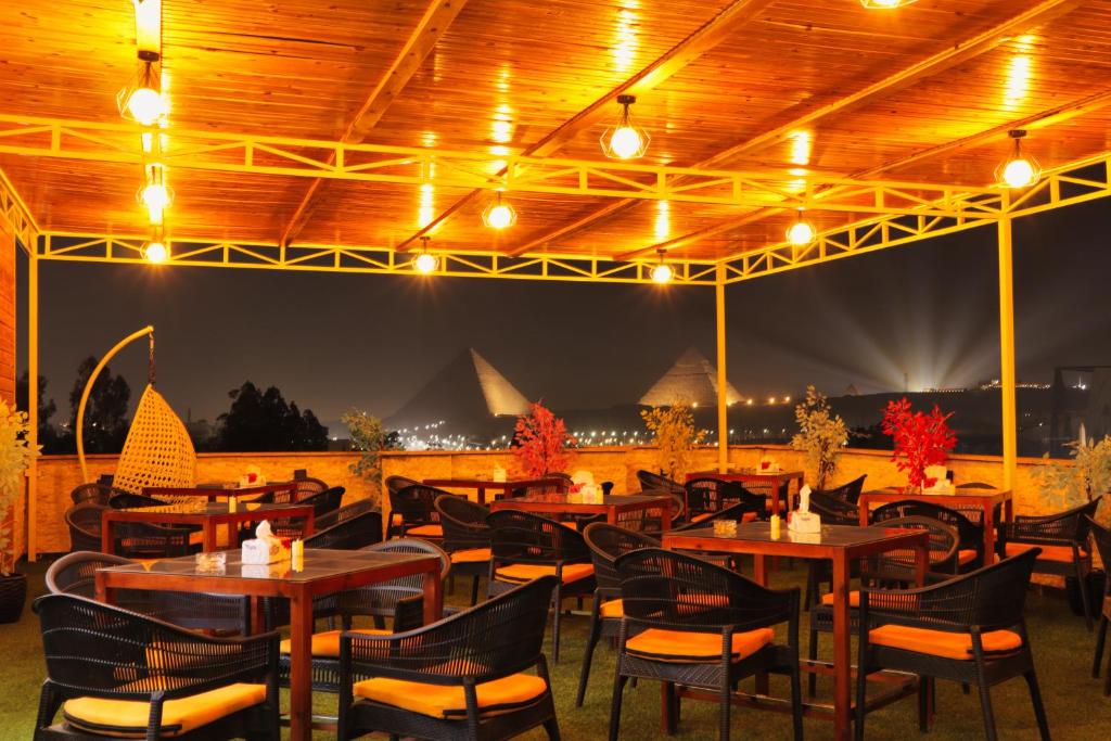 Warm evening lights on the rooftop with a view of the Giza Pyramids at night