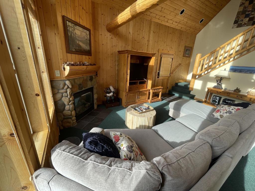 a living room with a couch and a fireplace at Forest Ridge home in Redmond