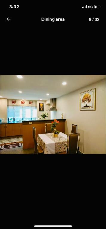 a dining area with a table and chairs with a table at Parnell pavilion-Elegant escape at Central Auckland in Auckland