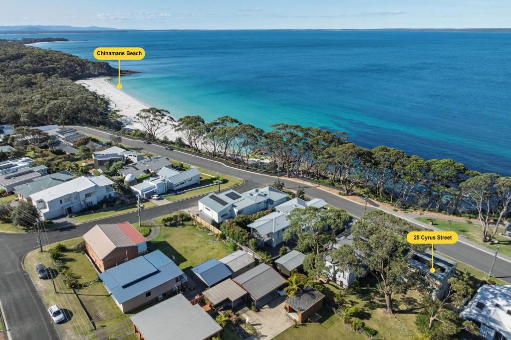 an aerial view of a suburb with houses and the ocean at Rowse House Hyams Beach in Hyams Beach