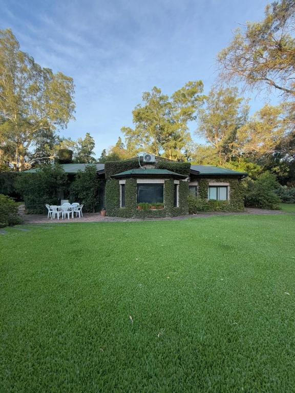 a brick house with a lawn in front of it at Quinta en Pilar - cerca del Polo in Pilar