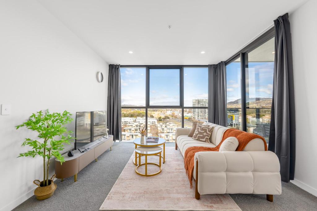 a living room with a couch and a table at Stylish Woden 2BR, Near Hospital, CIT, Westfield in Phillip
