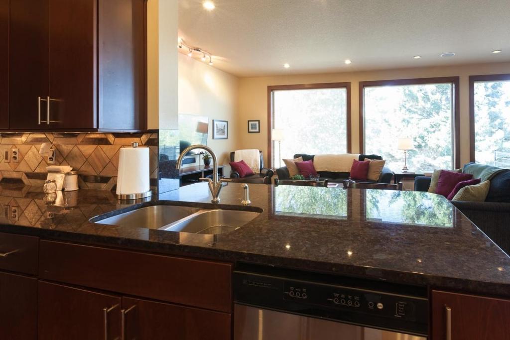 a kitchen with a sink and a living room at Downwider at The Columbia River Gorge in Hood River