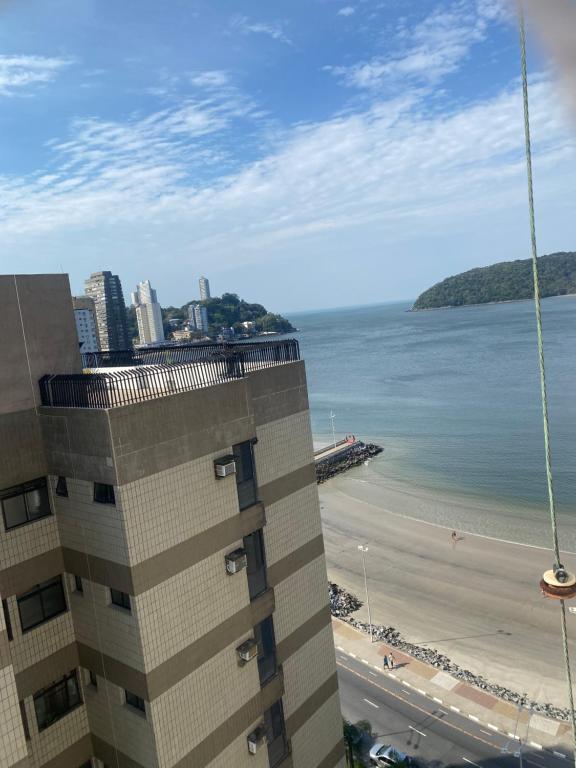 a view of a building and the beach at Apê 126 - Vista Mar in São Vicente