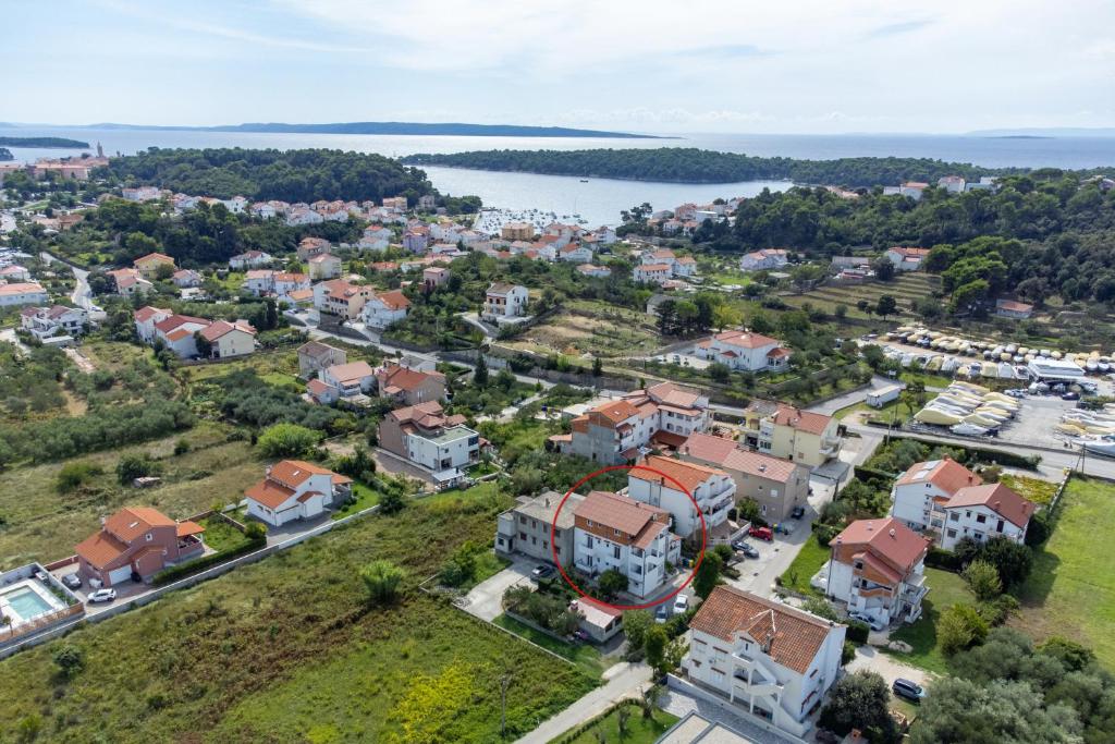 an aerial view of a town with houses and a lake at Apartments with parking space Palit, Rab - 22676 in Rab