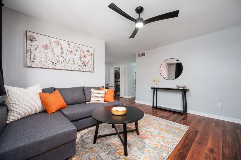 a living room with a couch and a ceiling fan at The Serene Escape, 5 minutes to ATL airport in Atlanta