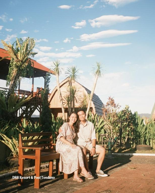 a man and a woman sitting on a bench at D88 Resort in Remboken