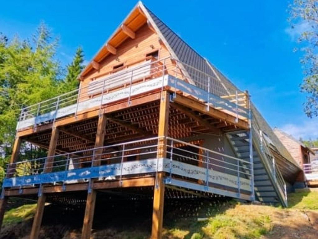 a house under construction with a roof at Grand chalet moderne pour 14 pers à Super Besse - FR-1-814-150 in Super Besse