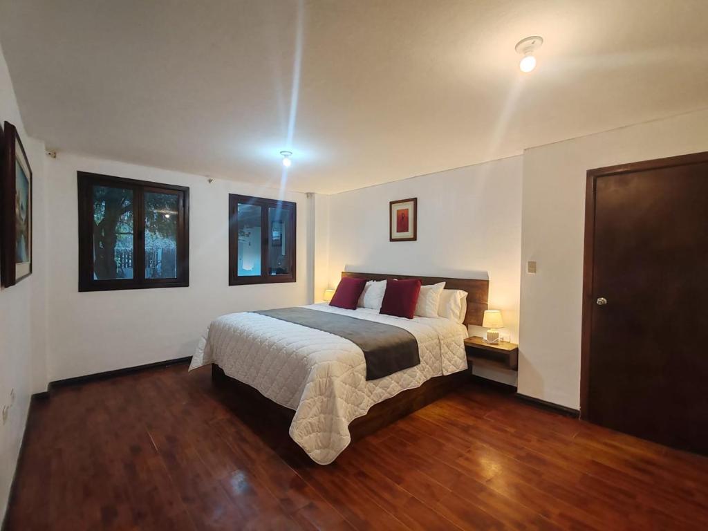 a bedroom with a bed and a wooden floor at casa Montisora in Baños