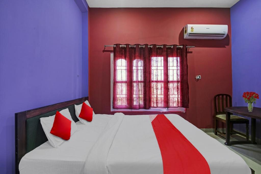 1 dormitorio con 1 cama con paredes rojas y moradas en Hotel O Brahmaputra Stay, en Dibrugarh