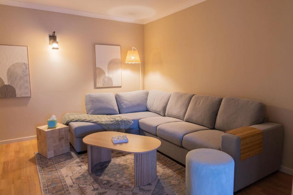 a living room with a couch and a table at Busselton Breeze in Busselton