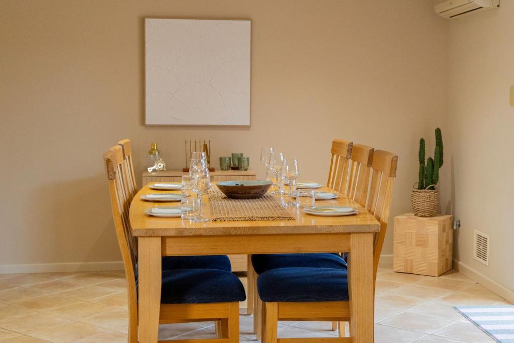 a wooden table with chairs and a dining room at Busselton Breeze in Busselton