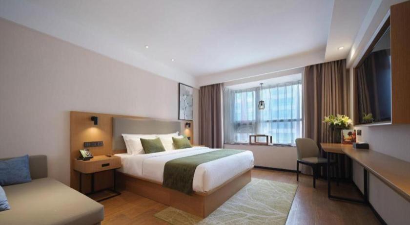 Ένα ή περισσότερα κρεβάτια σε δωμάτιο στο GreenTree Inn Luoyang Railway Station Wangfujing Wangcheng Park