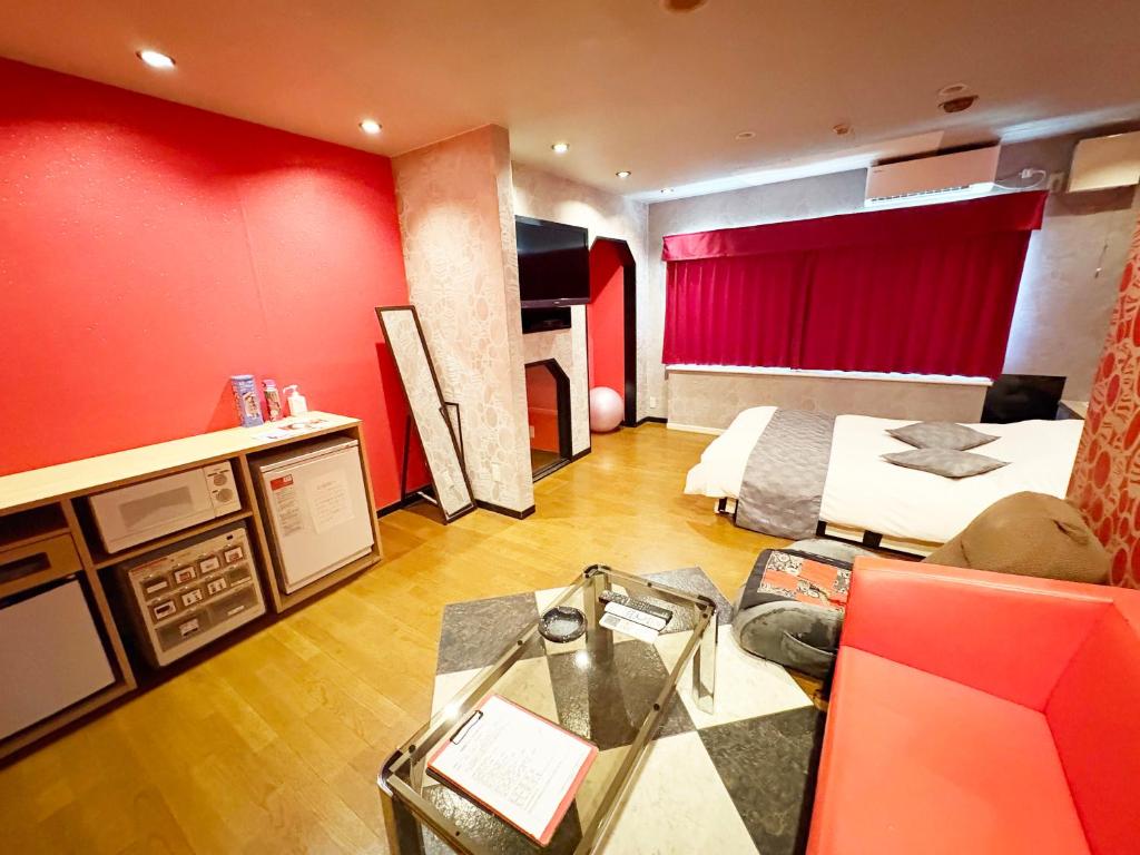 a hotel room with a bed and a couch at ハニー in Yokoshima