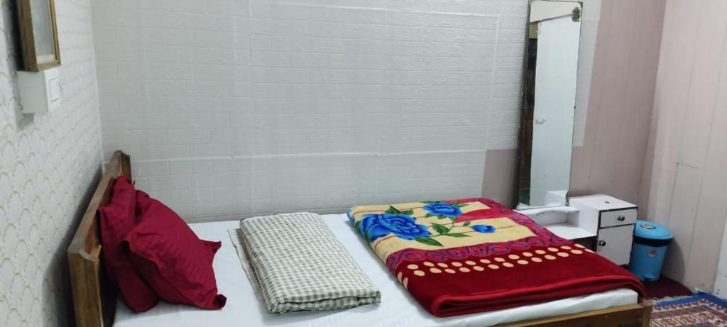 a bed with a blanket on top of it at Lali Guras Homestay Simana in Darjeeling