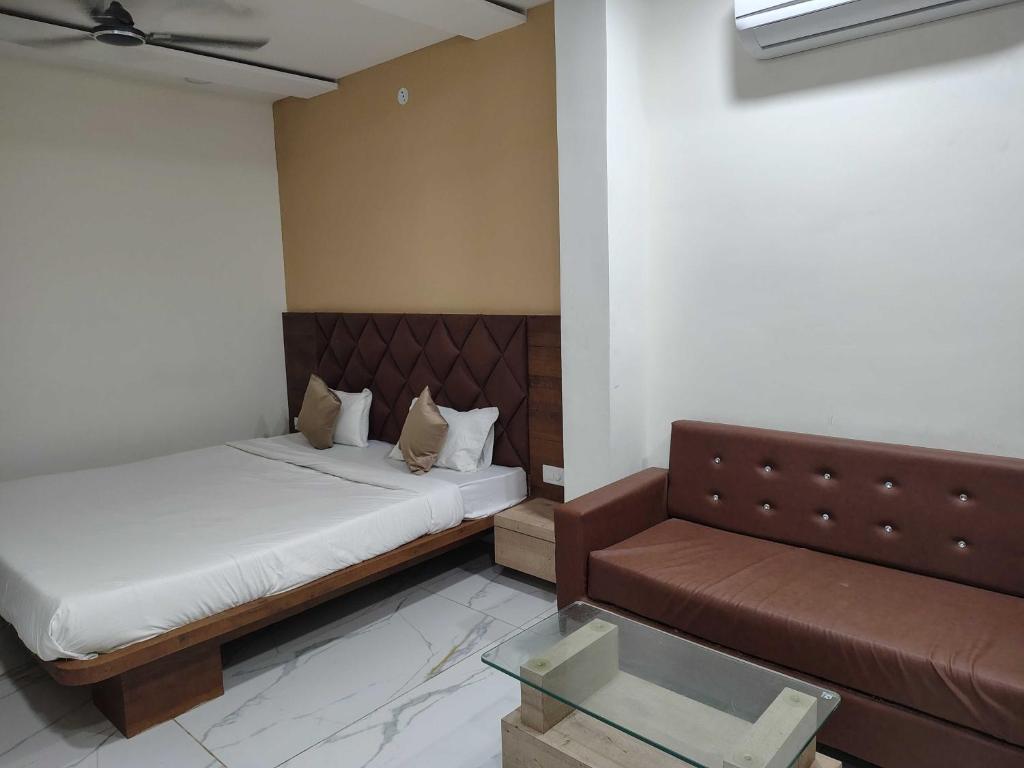 a room with two beds and a couch in it at Hotel O Eternity Stays in Rao