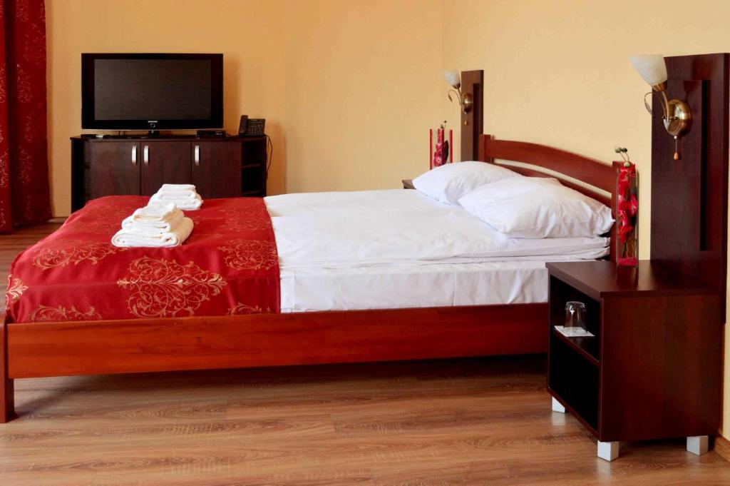 Postel nebo postele na pokoji v ubytování Sting Hotel & Event Palace