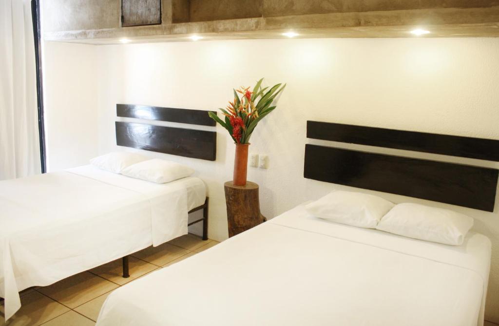 Postel nebo postele na pokoji v ubytování Hotel Maya Rue