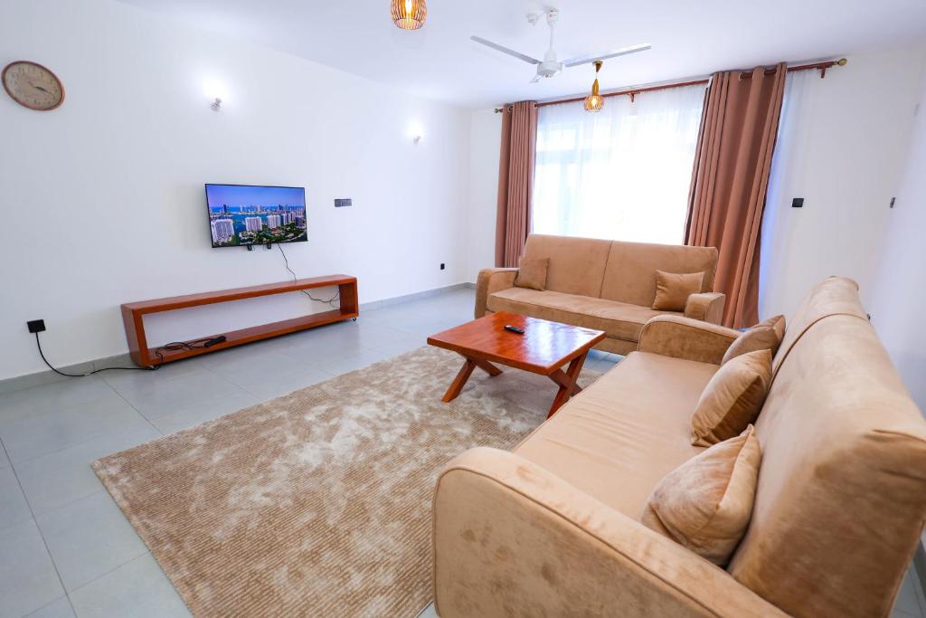 a living room with a couch and a table at Casacylen in Mombasa