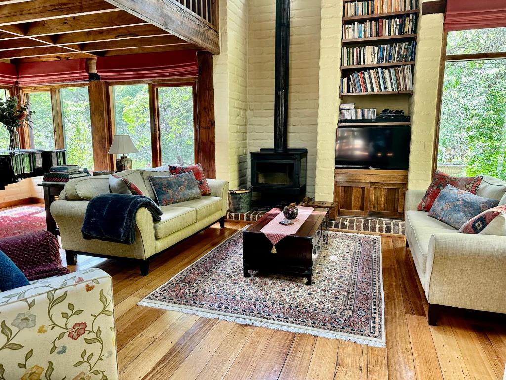 a living room filled with furniture and a fireplace at Coral Fern Retreat in Forrest
