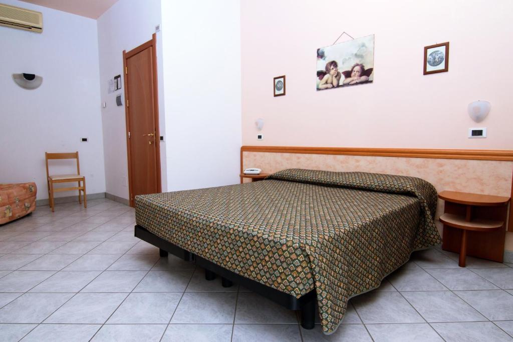 Postel nebo postele na pokoji v ubytování Hotel President